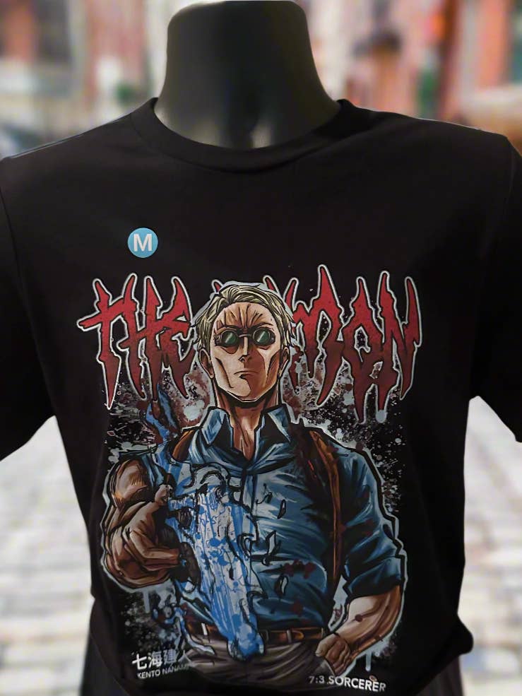 Black t-shirt with graphic design of a character holding a gun on a mannequin against a blurred background.
