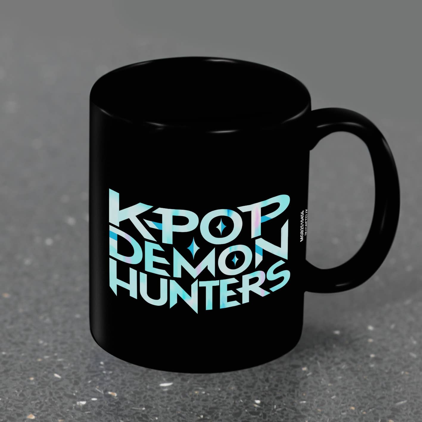 Black mug with 'KPOP DEMON HUNTERS' text on a gray background
