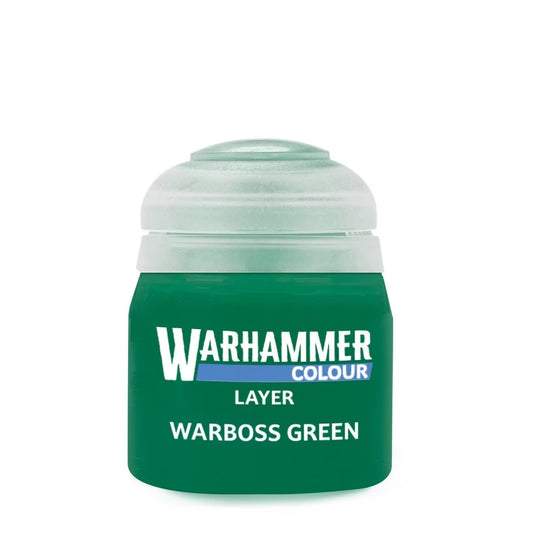 A jar of Warhammer Colour Layer paint in Warboss Green, featuring a translucent green cap and a dark green body with white and blue text, on a plain white background.