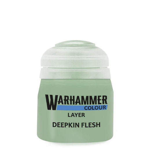 A bottle of Warhammer Colour Layer Deepkin Flesh acrylic paint, featuring a pale green body, a translucent cap, and black and blue text on the front, set against a plain white background.