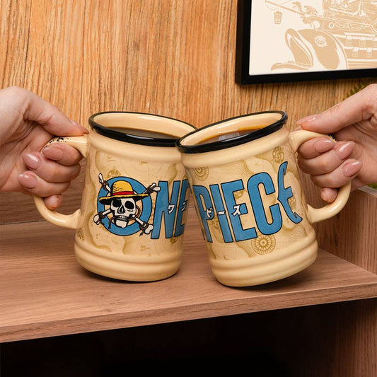 Two 'One Piece' themed mugs held by hands on a wooden surface.