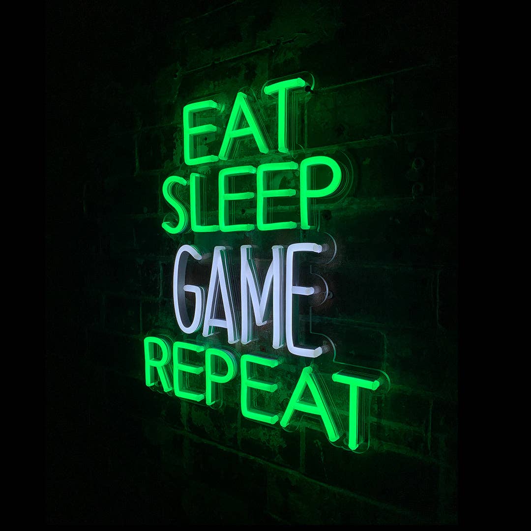 Neon sign with 'Eat Sleep Game Repeat' text on a dark background