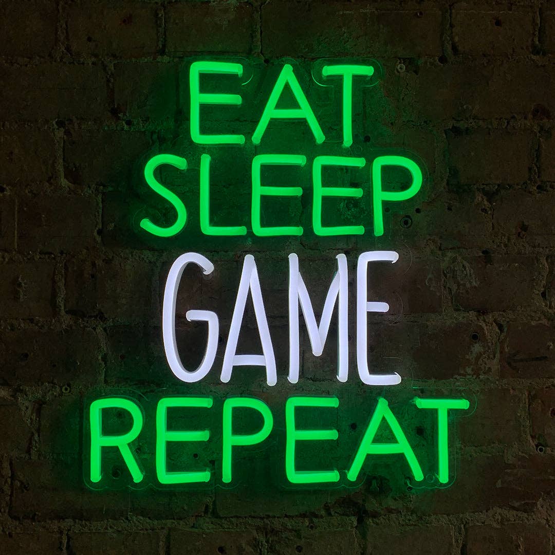Neon sign with 'Eat Sleep Game Repeat' text on a brick wall background