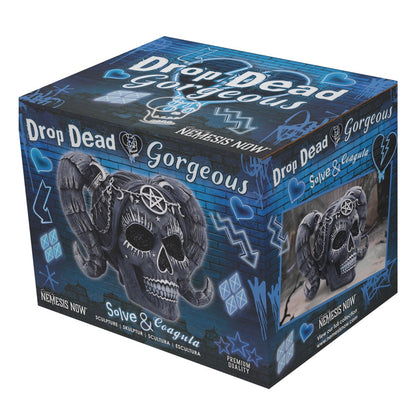 Box of 'Drop Dead Gorgeous' with decorative skull design on a blue background