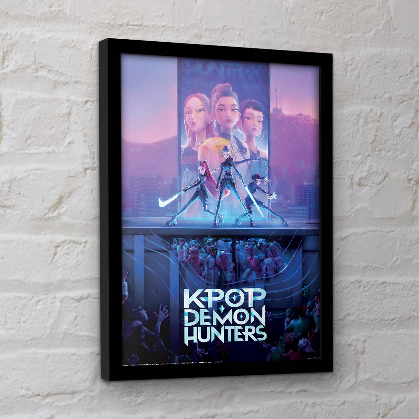 Framed poster of 'K-Pop Demon Hunters' with characters and text on a white brick wall background.