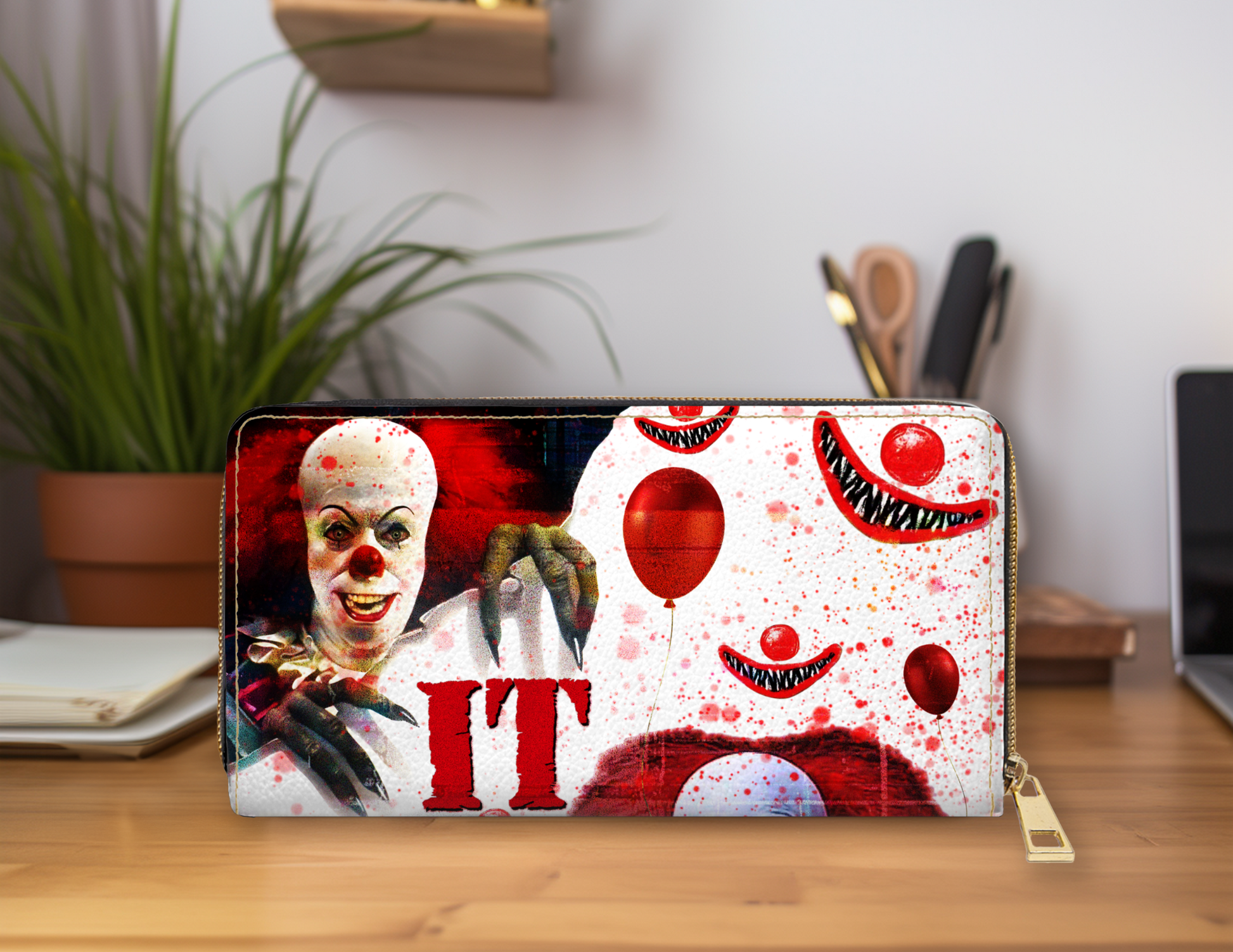 Clown-themed wallet with 'IT' design on a desk
