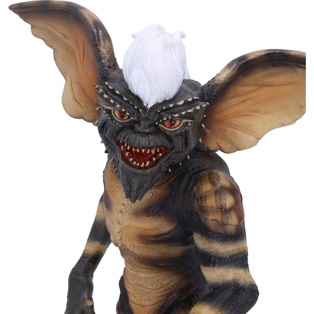 Monster figurine with large ears and red eyes on a white background