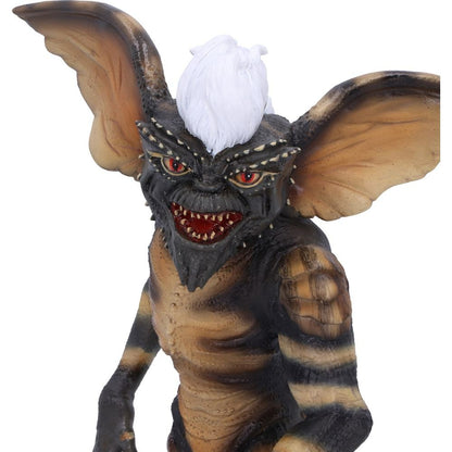 Monster figurine with large ears and red eyes on a white background