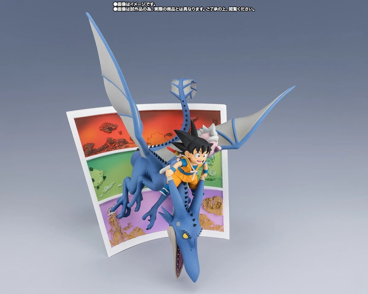 A Dragon Ball figure of Goku riding a blue dragon, displayed in front of a colorful landscape card on a gray gradient background.