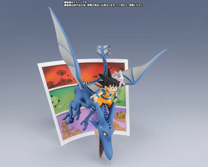 A Dragon Ball figure of Goku riding a blue dragon, displayed in front of a colorful landscape card on a gray gradient background.