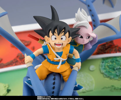 Dragon Ball figure set featuring Goku in an orange gi riding a blue vehicle with Vegeta behind him, shown against a colorful illustrated backdrop.