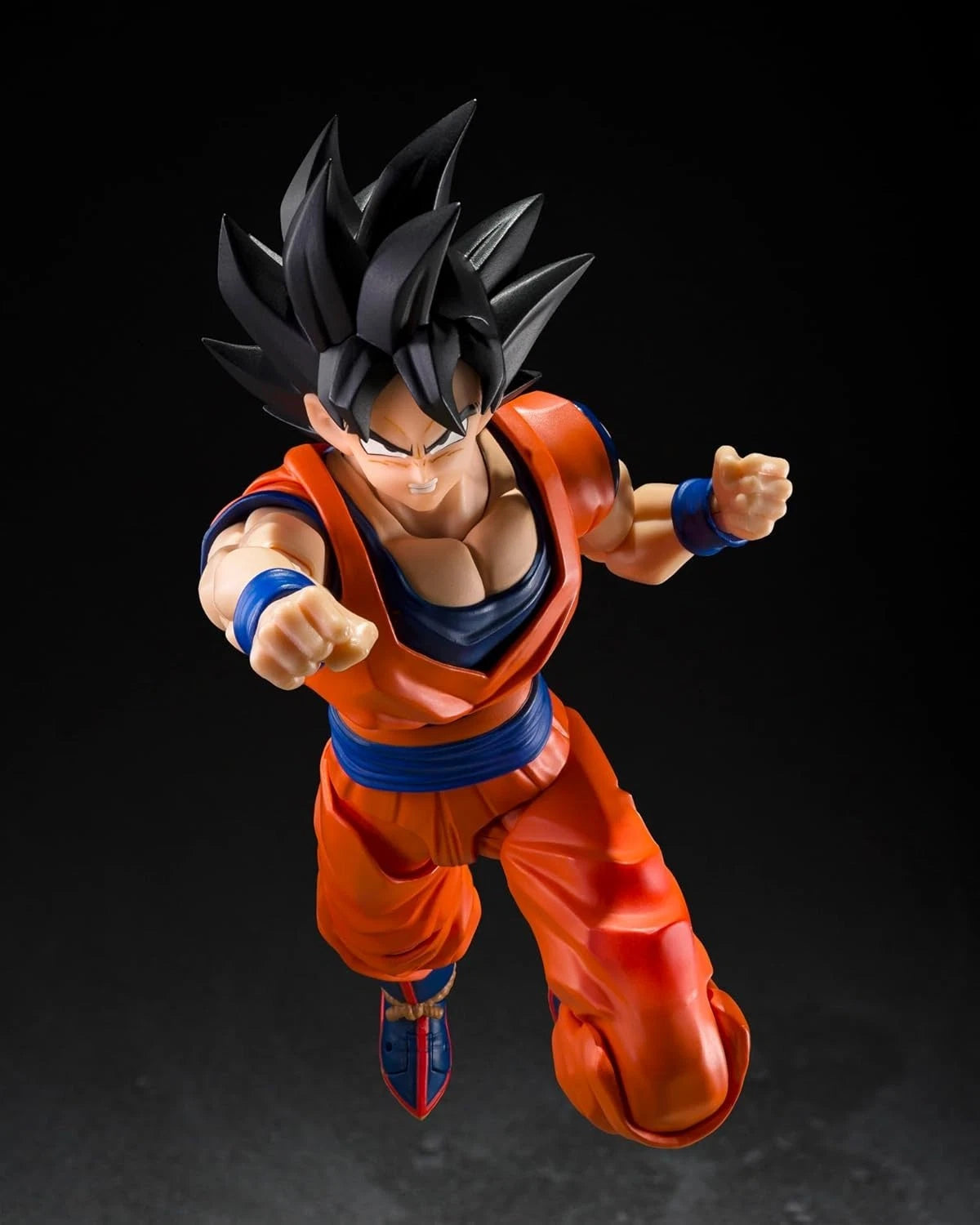 Action figure of a character in an orange and blue outfit on a black background